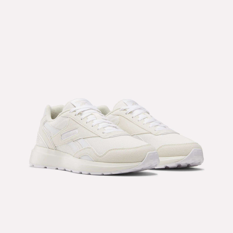 Women's GL1100 Shoes by Reebok, featuring an off-white design with lightweight mesh and suede panels, white laces, and a textured rubber sole, shown on a plain white background.