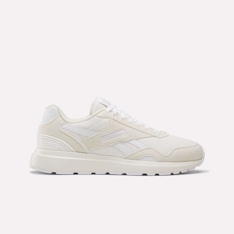 The Women's GL1100 Shoes by Reebok are white athletic sneakers with side stripes, a textured sole, and subtle branding, shown in profile on a plain white background—perfect for comfortable everyday wear.