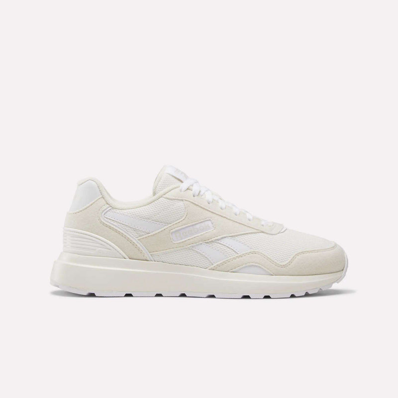 The Women's GL1100 Shoes by Reebok are white athletic sneakers with side stripes, a textured sole, and subtle branding, shown in profile on a plain white background—perfect for comfortable everyday wear.