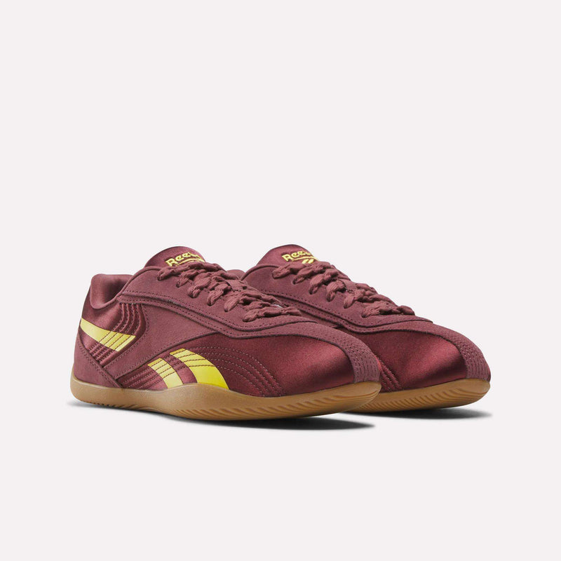 The Reebok Women's Ultra Lo Shoes feature a maroon color and low-profile design, offering lightweight comfort and everyday style.