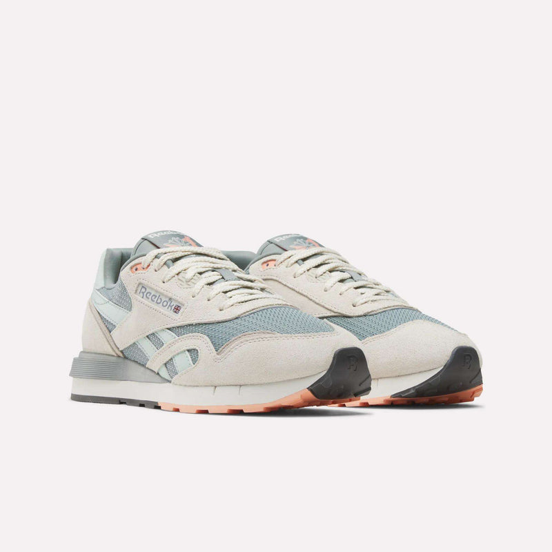 Reebok Classic Nylon 89 Shoes in pastel beige and light blue with white accents, grey soles, and peach details feature a cushioned midsole. Displayed side by side against a plain white background.