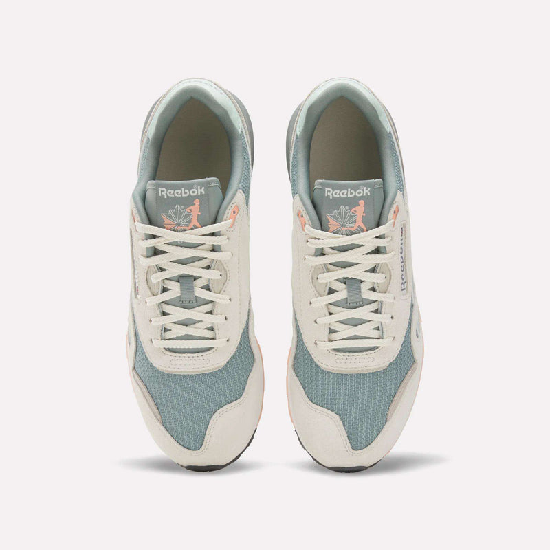 A top view of the Reebok Classic Nylon 89 Shoes shows light blue mesh, off-white suede overlays, and white laces. The cushioned midsole adds comfort, while insoles feature a pink flamingo with leaves for a unique touch.