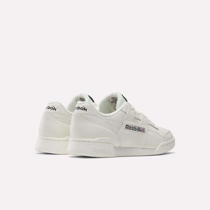 Shown from the back and side, these white Reebok Workout Plus Shoes feature the brand's logo and Union Jack flag—ideal for capturing a classic fitness style.