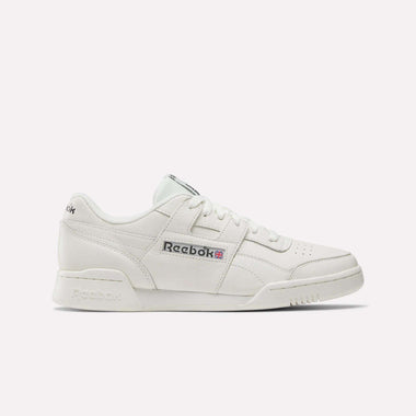 The Reebok Workout Plus Shoes are white sneakers with classic '80s fitness style, a lace-up front, perforated toe, and Reebok logo with Union Jack on the side, shown against a plain light background.