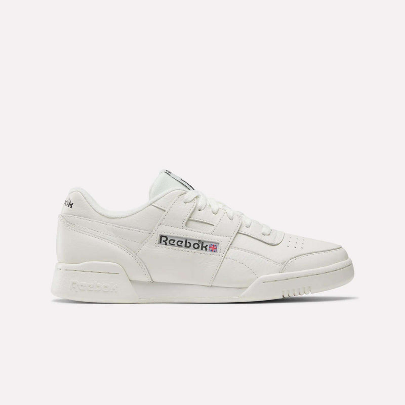 The Reebok Workout Plus Shoes are white sneakers with classic '80s fitness style, a lace-up front, perforated toe, and Reebok logo with Union Jack on the side, shown against a plain light background.