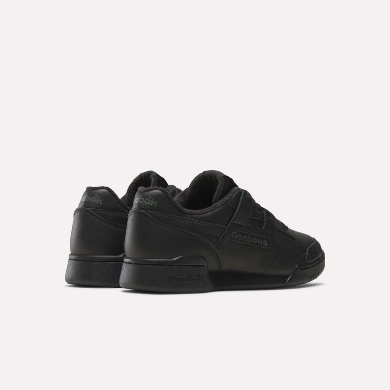 A pair of Women's Workout Plus Shoes by Reebok are shown angled backwards on a plain white background, with the Reebok logo on the heel and side, reflecting classic '80s fitness style.