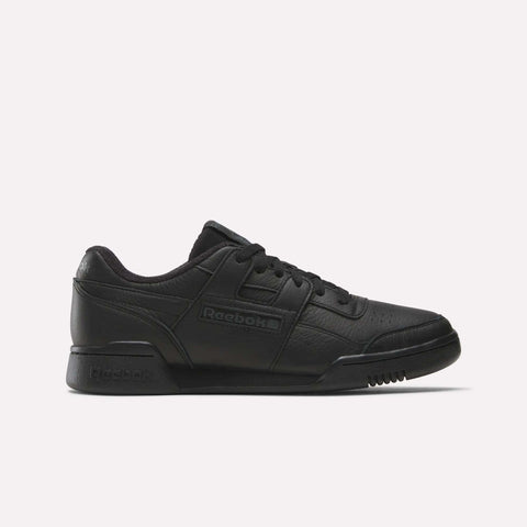 The Reebok Women's Workout Plus Shoes feature a black leather upper, low-top design, lace-up closure, and classic Reebok logos on the side and heel, reflecting iconic '80s fitness style. Shown against a plain white background.