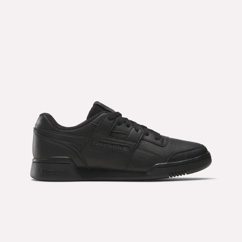 The Reebok Women's Workout Plus Shoes feature a black leather upper, low-top design, lace-up closure, and classic Reebok logos on the side and heel, reflecting iconic '80s fitness style. Shown against a plain white background.