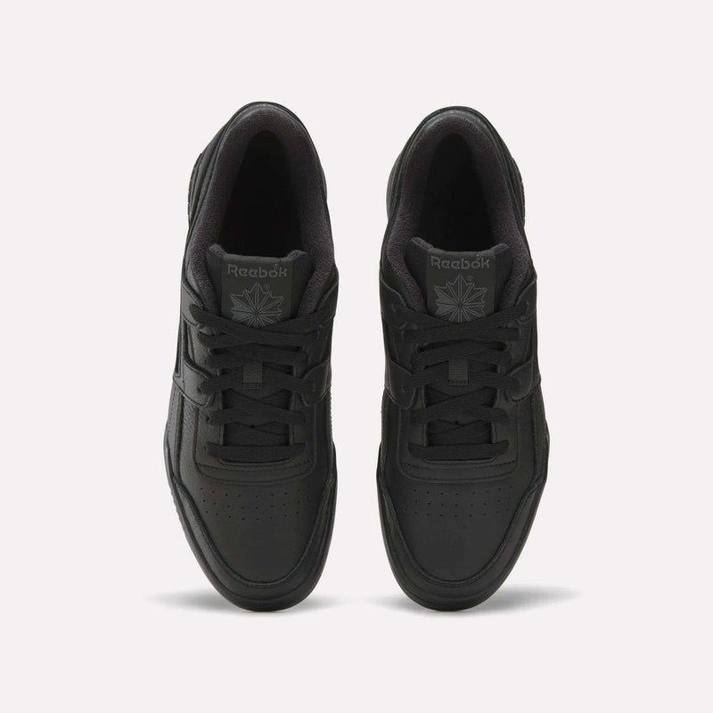 A pair of Women's Workout Plus Shoes by Reebok in black, shown from above with visible laces on a plain white background—celebrating iconic '80s fitness style.