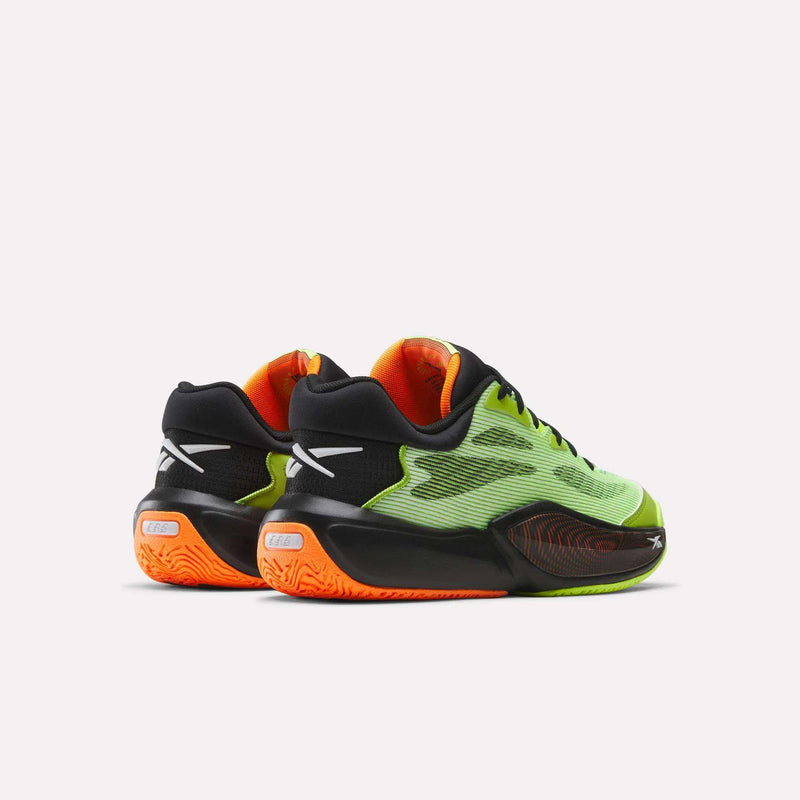 The Reebok Engine A 26 Basketball Shoes feature lime green mesh uppers, black and orange accents, black soles with orange highlights, and white heel logos. Designed for stability and energy return, they're shown from the back and side on a white background.