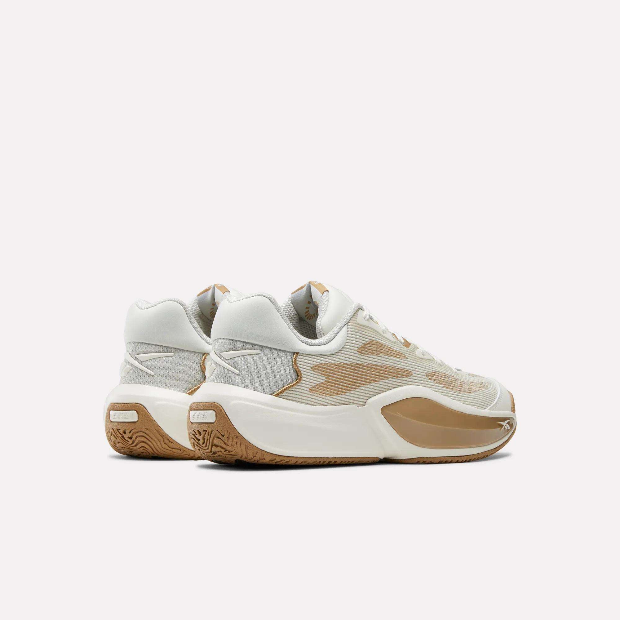 The Reebok Engine A 26 Basketball Shoes, in light beige and white with textured midsoles, gum outsoles, and mesh panels, are displayed side by side on a plain white background.