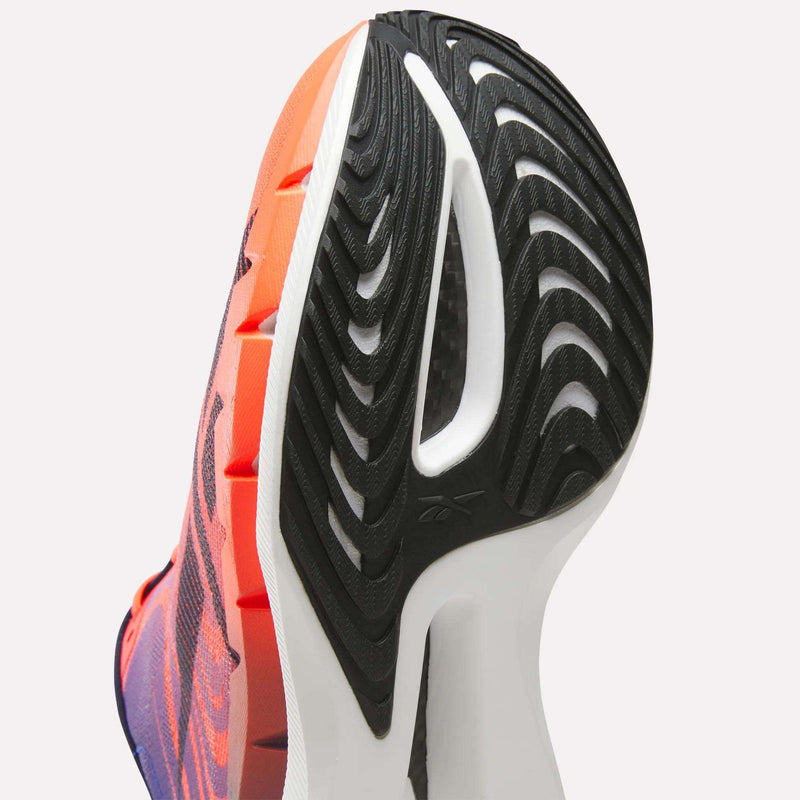 Close-up of the underside of a Reebok SpeedShifter running shoe, highlighting the black rubber tread pattern and white HyperFloat foam midsole.