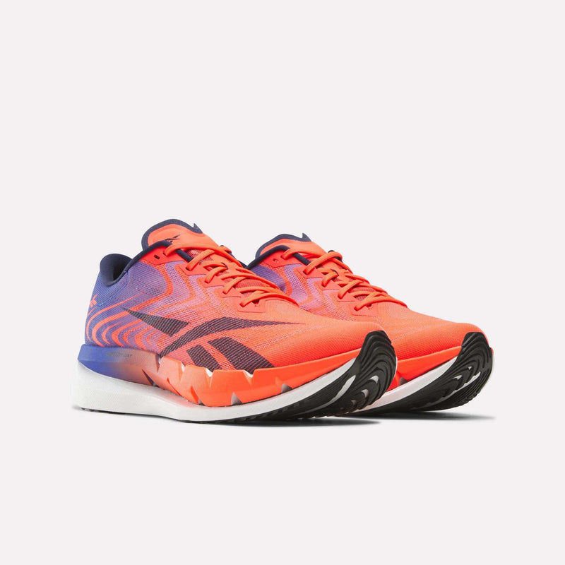 Orange and purple Reebok SpeedShifter running shoes featuring a thick HyperFloat foam sole with black tread.