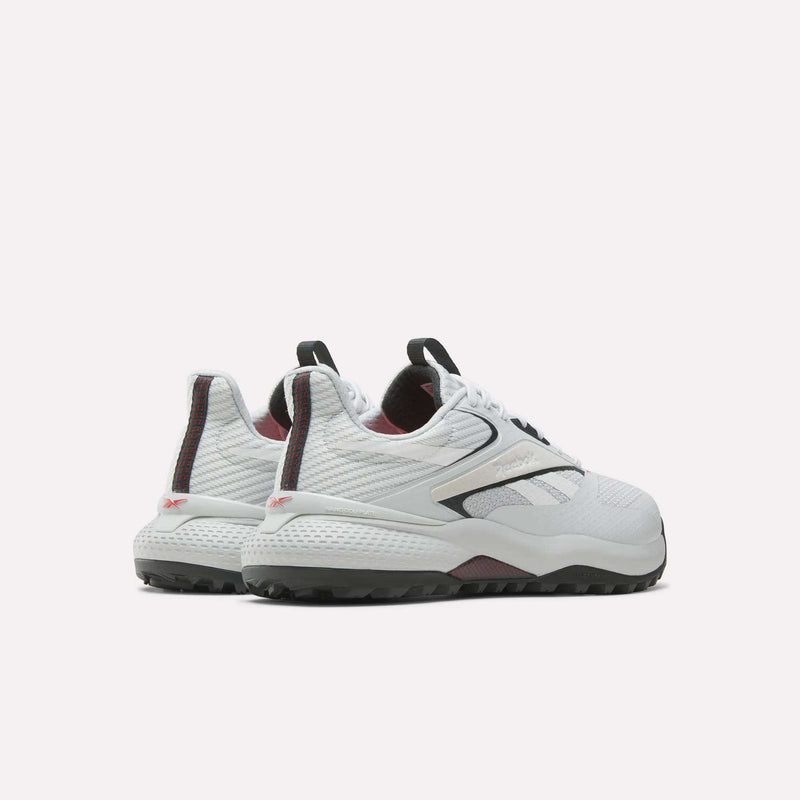 A pair of Reebok Nano Golf Shoes in white, featuring black and maroon accents, shown from the back and side with textured soles and a lightweight mesh FlexWeave upper on a plain white background.
