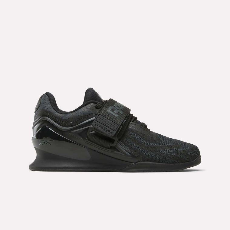The Reebok Women's Legacy Lifter IV Training Shoes feature a thick sole, mesh upper, and wide midfoot strap, offering support and stability for weightlifting.