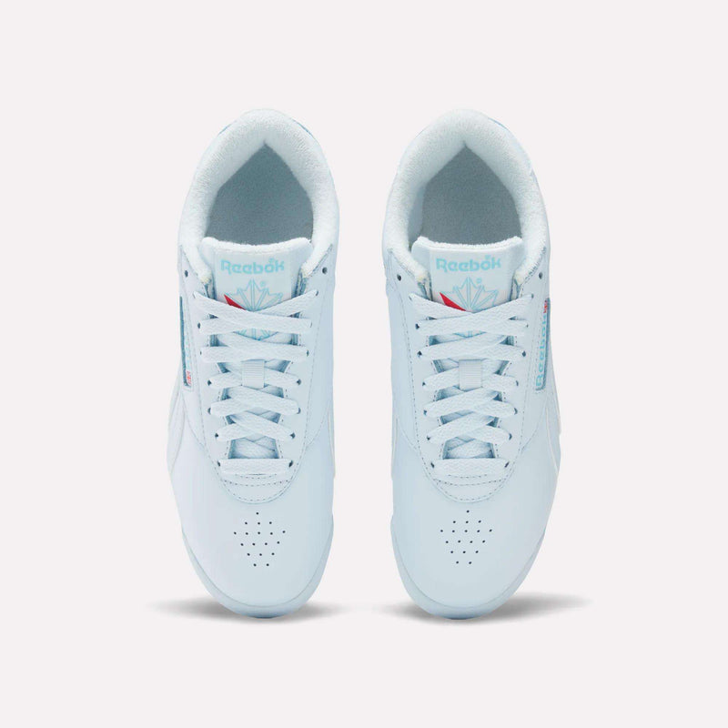 A top-down view of Reebok Women's Freestyle Lo Shoes—white leather sneakers with laces, light blue accents, and the Reebok logo on the tongue and side—designed for everyday wear.