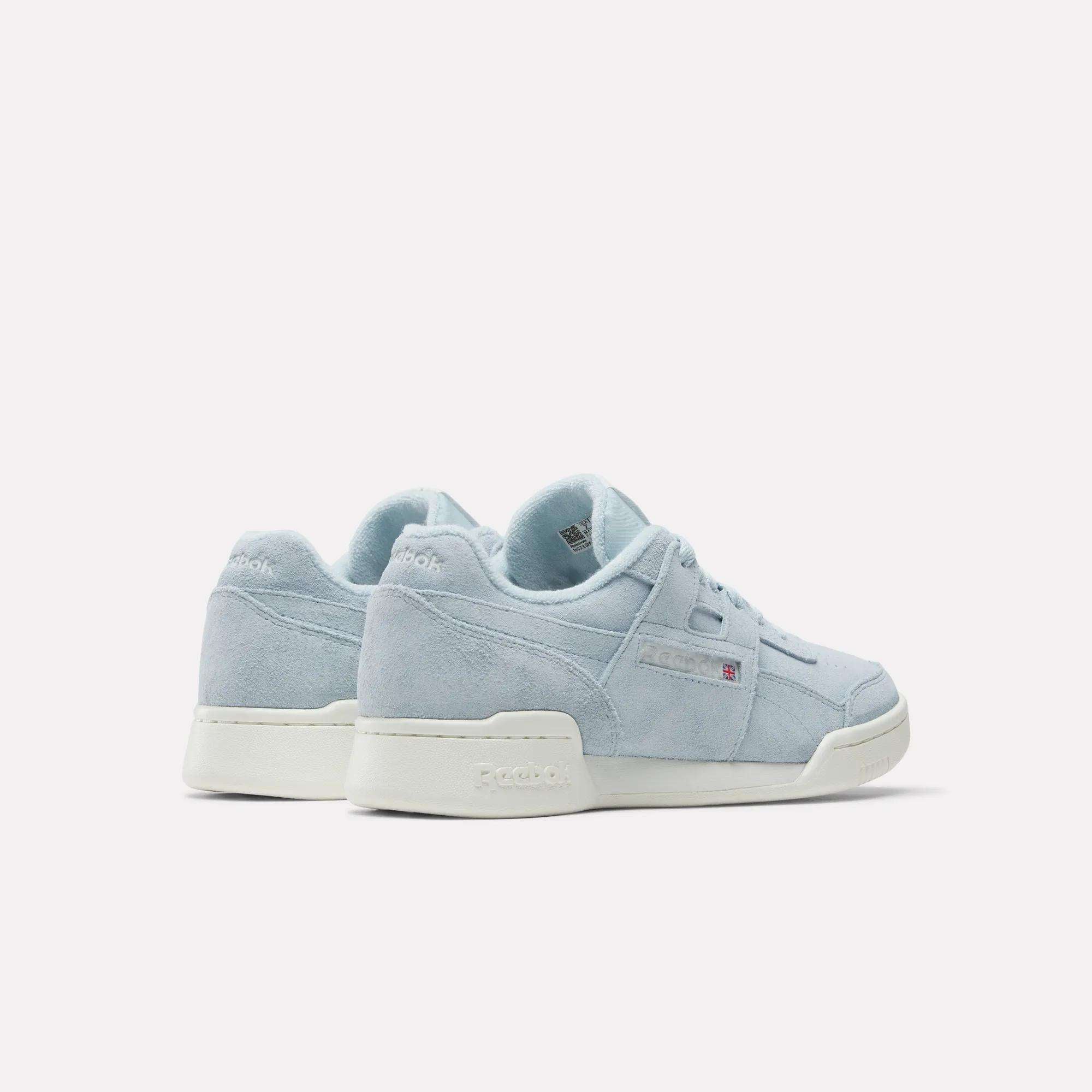 The Women's Workout Plus Shoes by Reebok are shown in light blue suede with white soles on a white background, angled to display both the side and back—evoking classic '80s fitness style.