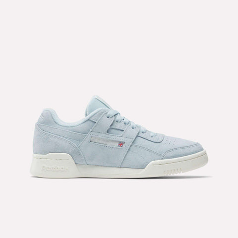 The Reebok Women's Workout Plus Shoes feature light blue suede, a white sole, side stitching details, perforated toe, and a small Reebok logo on the side—showcasing classic '80s fitness style against a plain white background.