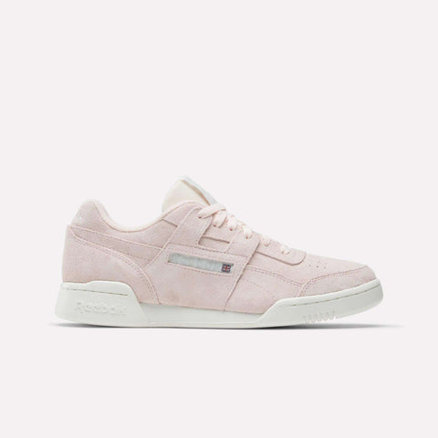 The Reebok Workout Plus Shoes feature light pink suede, white laces, and a white sole—an '80s-inspired workout sneaker shown in profile on a plain white background.