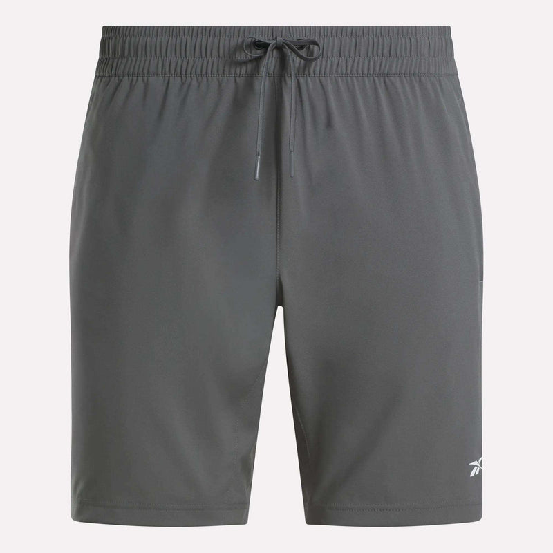Reebok Men's Woven Shorts in dark gray feature sweat-wicking fabric, an elastic waistband with drawstring, and a small white logo on the lower left leg. The plain design is ideal for any workout.