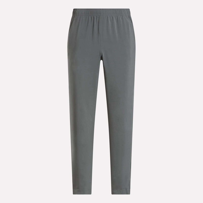 The Reebok Men's Train Woven Unlined Pants in plain gray feature an elastic waistband and are perfect as lightweight workout pants for the gym or everyday comfort, shown here against a light background.