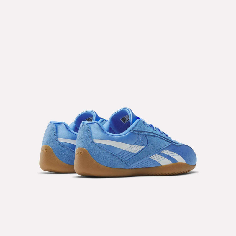 A pair of lightweight Women's Ultra Lo Shoes by Reebok in light blue with white side stripes and brown gum soles, shown from the back and side on a plain white background.