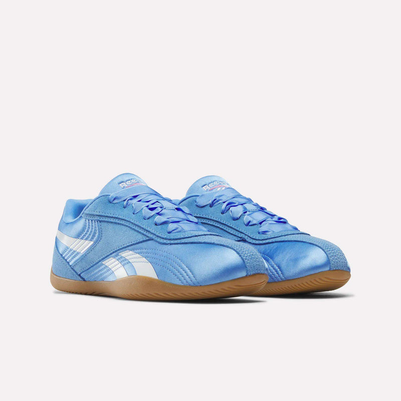 A pair of Reebok Women's Ultra Lo Shoes in light blue with white side stripes and tan rubber soles, shown on a plain white background.