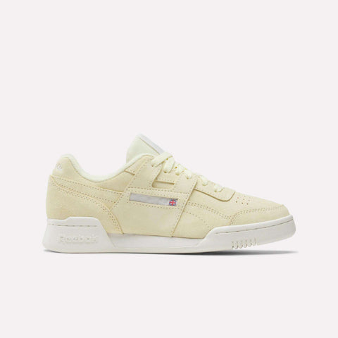 The Reebok Women's Workout Plus Shoes feature a beige suede finish, white sole, and tonal laces, shown in side profile against a white background—a classic '80s-inspired sneaker for women's fitness style.