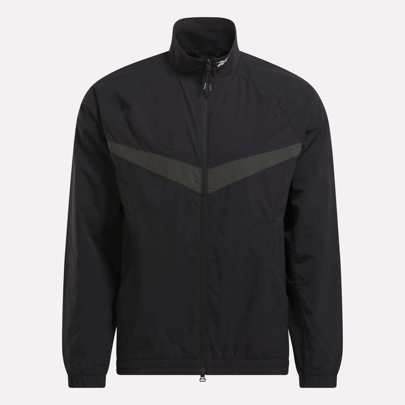 The Reebok Warm Up Track Jacket features a black zip-up design with a stand-up collar, elastic cuffs, and a subtle dark grey chevron across the chest—ideal for basketball warmups or casual wear.