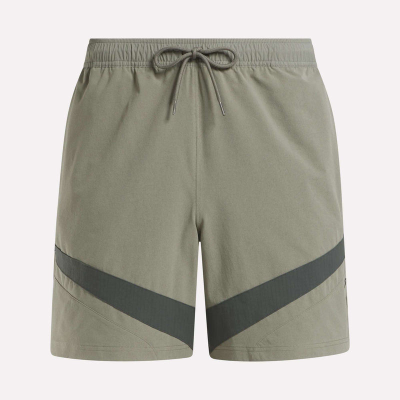 Reebok Woven Basketball Shorts in light olive green feature an elastic waistband with drawstring, dark diagonal stripes near the hem, and smooth, lightweight fabric—perfect for active wear or basketball enthusiasts.