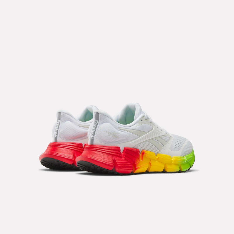 Reebok Women's FloatZig 2 SoleMates Running Shoes with chunky soles and a lightweight foam midsole, featuring a red-to-yellow-green gradient from heel to toe, shown on a plain white background.