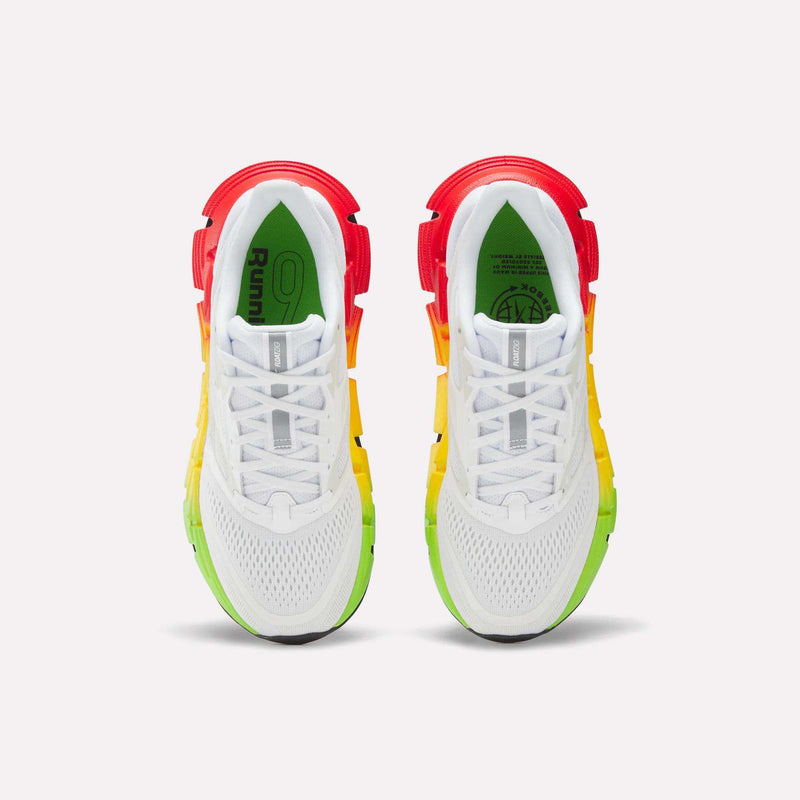 Reebok Women's FloatZig 2 SoleMates Running Shoes feature gradient soles shifting from green at the toes to yellow and red at the heels, plus a lightweight foam midsole. Shown from above on a plain white background.