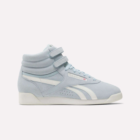 Reebok Women's F/S Hi Shoes in light blue feature a suede upper, two Velcro straps, white side stripes, perforated accents, and an off-white sole, shown against a plain white background.