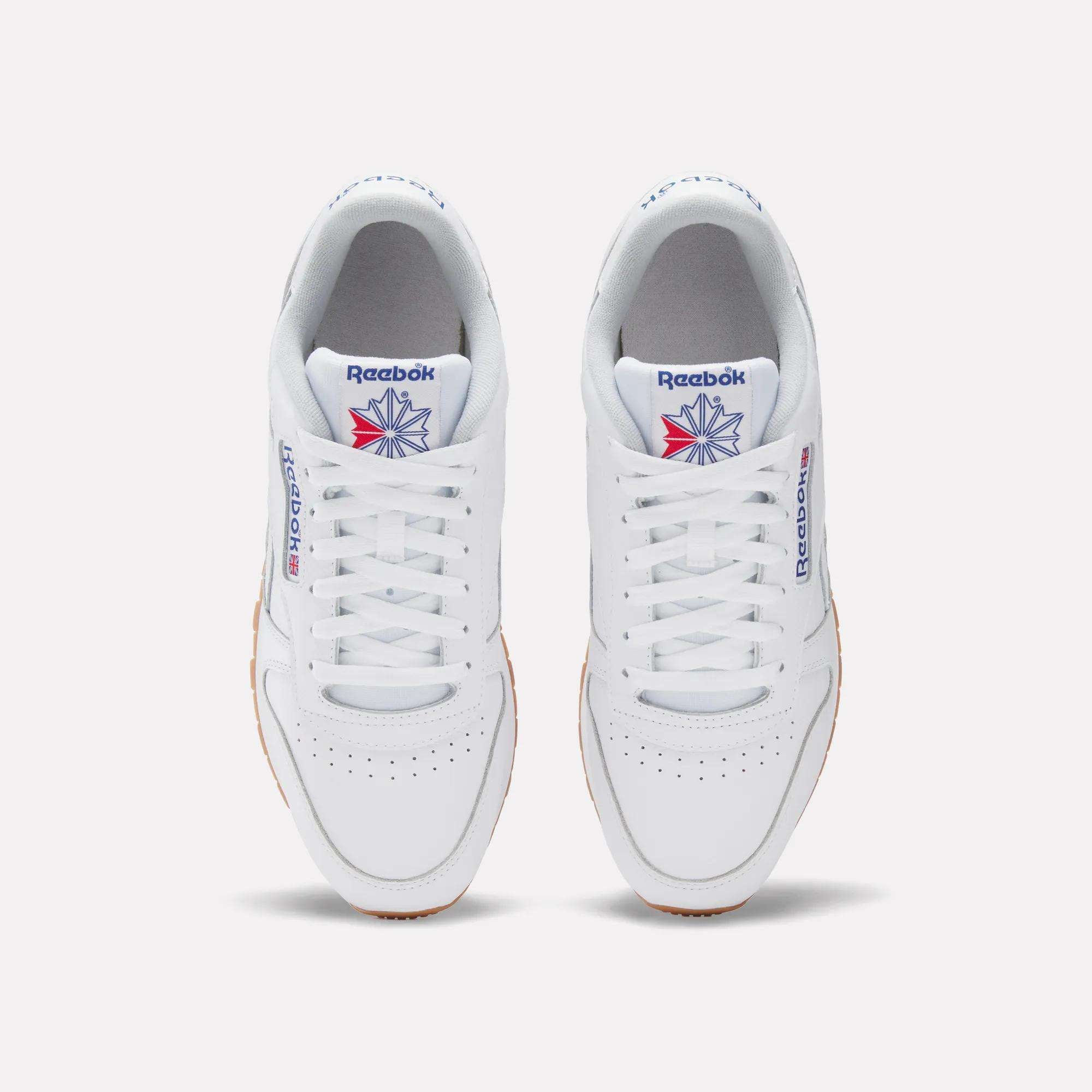 A pair of Reebok Classic Leather Shoes in white, seen from above, with white laces, a gum sole, and the iconic blue and red logo—these retro Reebok sneakers deliver timeless style.