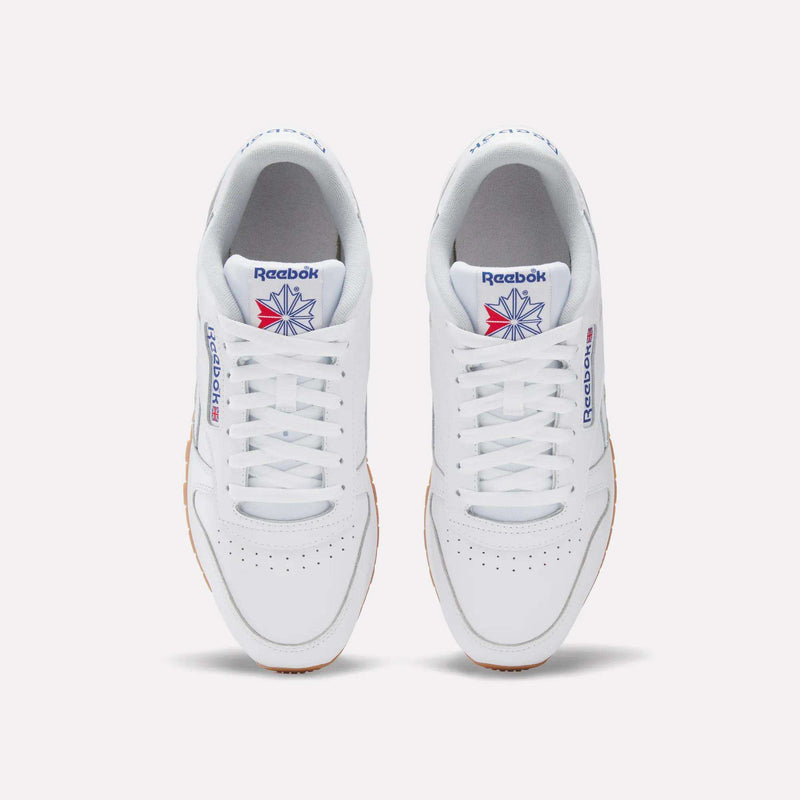 A pair of Reebok Classic Leather Shoes in white, seen from above, with white laces, a gum sole, and the iconic blue and red logo—these retro Reebok sneakers deliver timeless style.