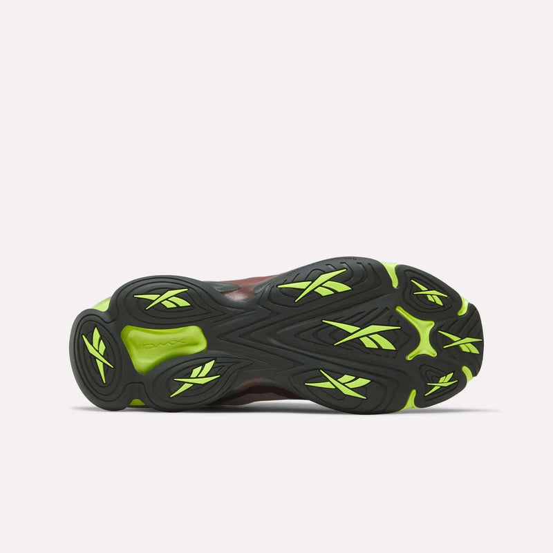 The image displays the black rubber outsole of Reebok DMX Series 3000 Shoes with neon yellow accents, viewed from below on a white background, showcasing DMX moving air technology for enhanced comfort.