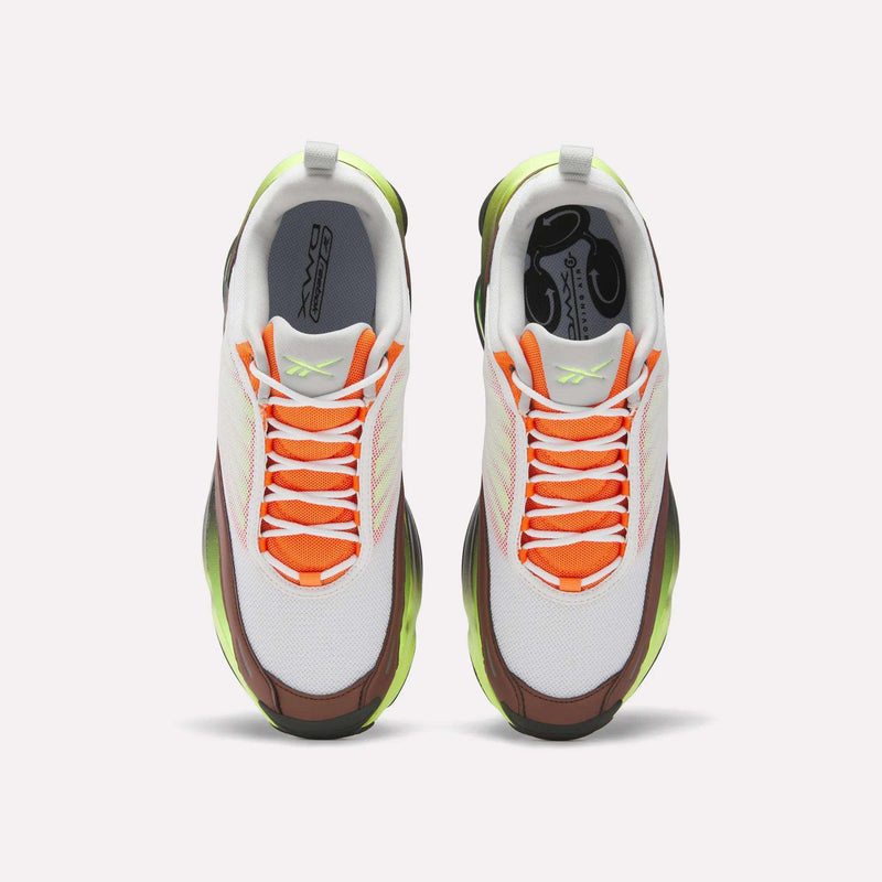 Top view of Reebok DMX Series 3000 Shoes with a white mesh upper, orange accents, neon green outsole, and brown details. Featuring DMX moving air technology for comfort, white laces, and signature Reebok branding.