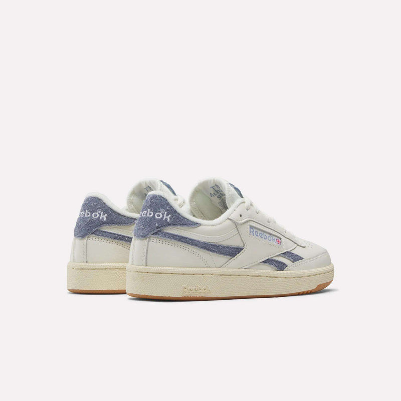 A pair of Reebok Women's Club C Revenge Shoes in white with blue suede accents, shown from the back and side on a plain light background.