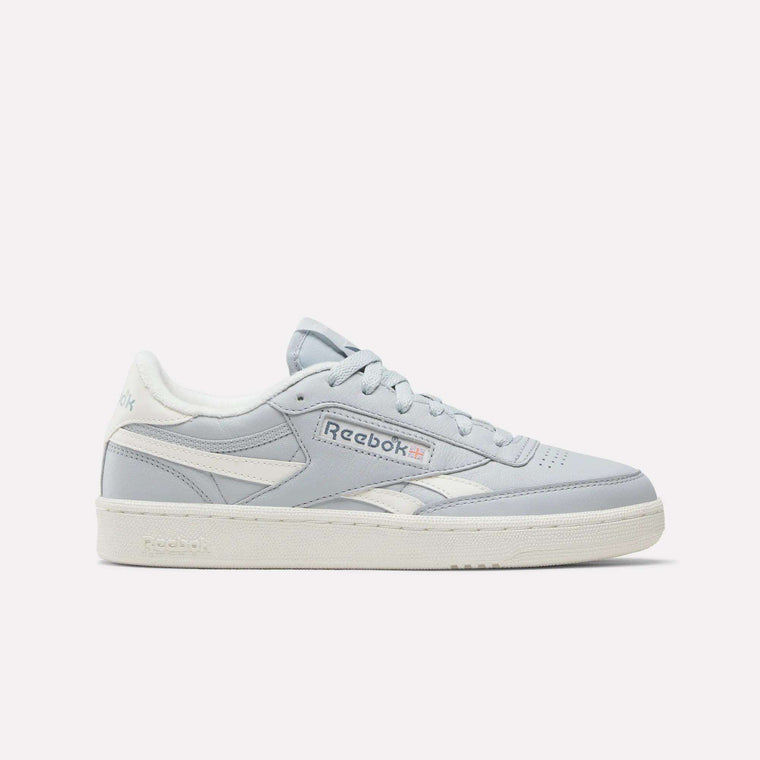 A pair of Women's Club C Revenge Shoes by Reebok in the Breeze/Chalk/Breeze colorway, featuring a classic side profile with vintage court-inspired style, white sole, subtle light blue accents, and a white Reebok logo, is presented against a plain white background.