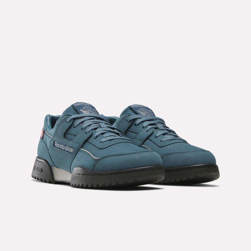A pair of Reebok Workout Plus Ripple Shoes in teal, featuring weather-ready construction with black soles and laces, displayed on a white background. Both shoes are angled slightly to the right, showcasing the side and front details of these water-repellant sneakers.