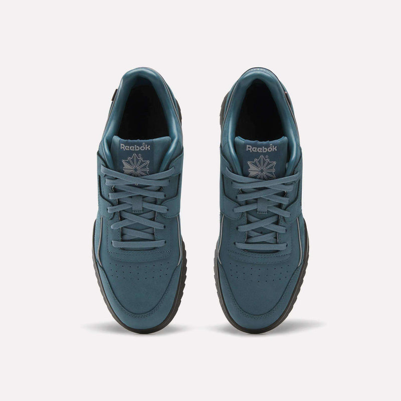 Top view of a pair of teal Reebok Workout Plus Ripple Shoes featuring laces, black ripple soles, and the Reebok logo with a starburst design on the tongue, placed side by side on a plain light background.