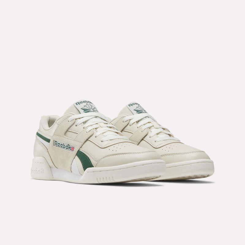 A pair of Reebok Workout Plus Shoes in beige leather with green accents and white soles, displayed against a plain white background.