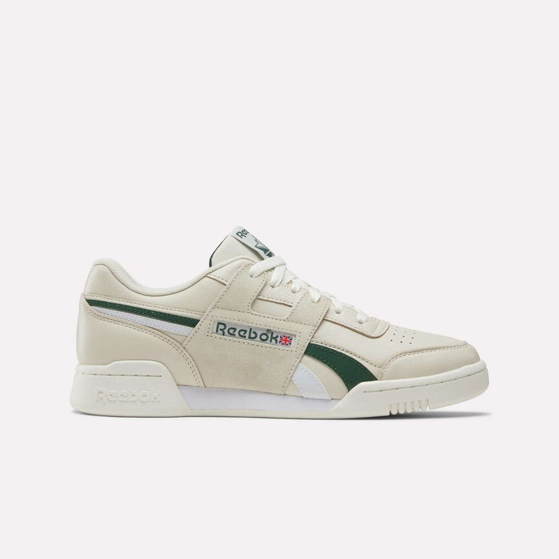 Showcased against a plain light background, the Reebok Workout Plus Shoes in Linen/Heritage Green/Chalk feature premium leather construction with green and white accents, the signature Reebok logo and Union Jack flag on the side, crisp white laces, and a clean white sole. Ideal for those looking for women’s shoes that offer timeless style paired with everyday comfort.