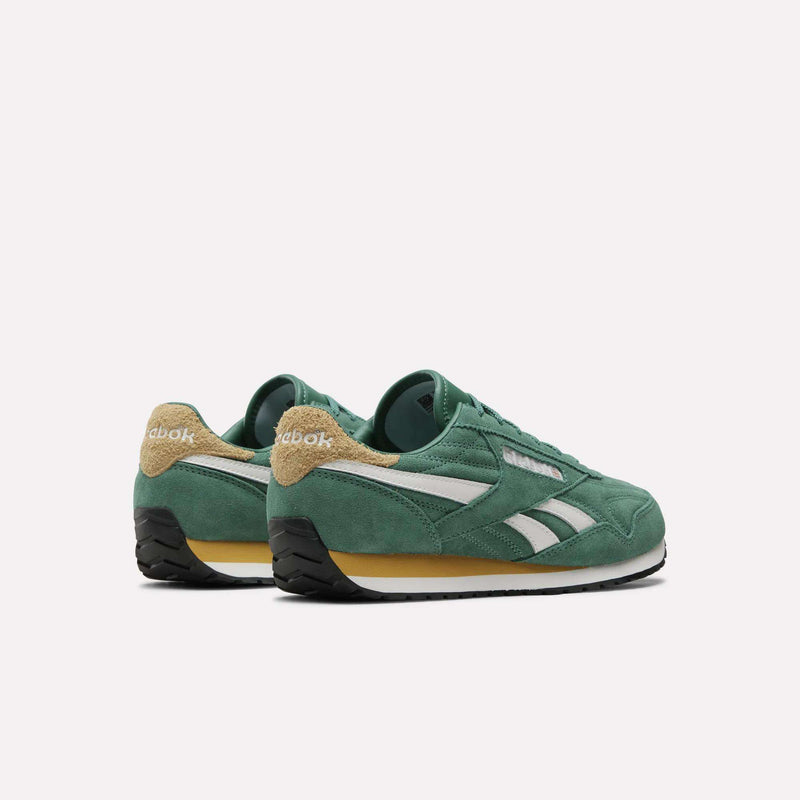 A pair of Women’s Classic AZ Shoes by Reebok in green, featuring white stripes, tan heel accents, and black soles, displayed on a white background—ideal for anyone seeking vintage-inspired sneakers with modern flair.