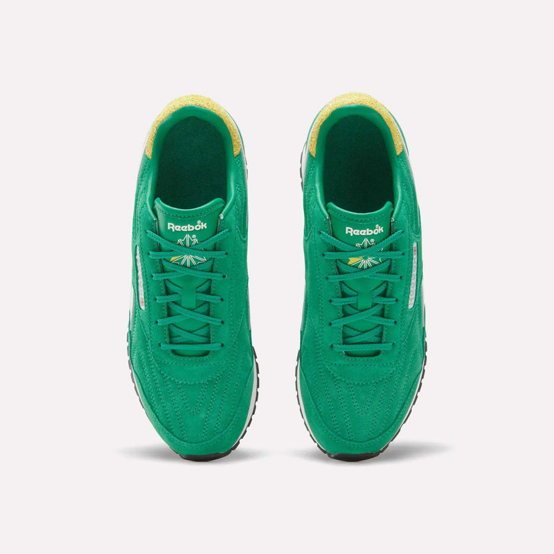 A pair of Reebok Women’s Classic AZ Shoes in vibrant green, featuring yellow inner lining, white Reebok logos on the tongues, and black-and-white soles, are displayed from an overhead view on a plain white background—these retro-inspired sneakers embody vintage flair for women’s footwear.