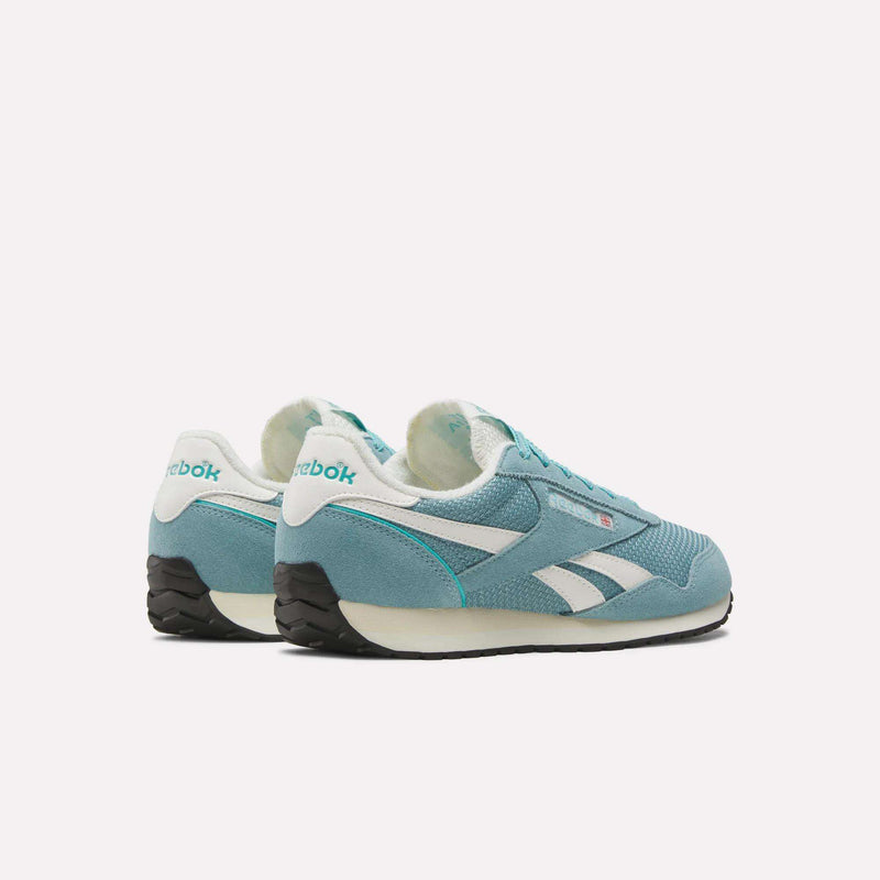 A pair of Women’s Classic AZ Shoes by Reebok in teal and white with black soles are displayed on a white background, angled to showcase the side and back logos. The textured design emphasizes both style and comfort, making them ideal for everyday wear.