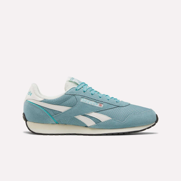 A Women’s Classic AZ Shoe by Reebok in Hazyteal, Twistedturquoise, and Chalk, featuring a crochet-style textile upper with white accents, white laces, and a black sole, is shown in profile facing right on a plain white background.