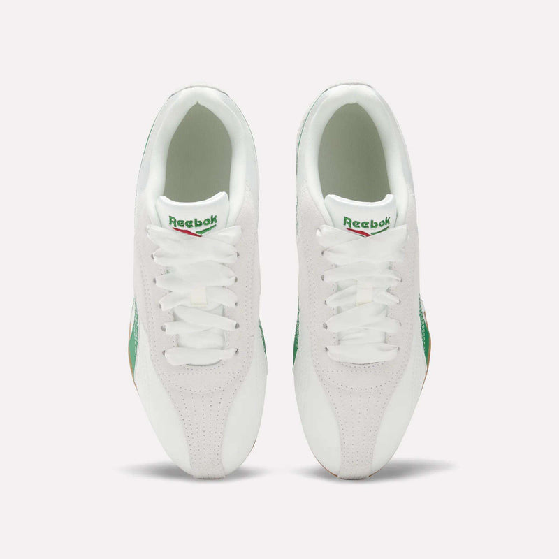 Top view of Women's Ultra Lo Shoes by Reebok: white sneakers with green accents and gum soles, placed side by side on a light background, featuring the visible Reebok logo on each tongue.