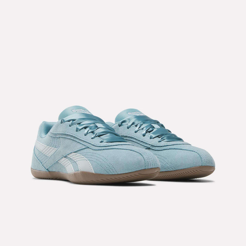 A pair of Reebok Women’s Ultra Lo Shoes in light blue with a suede upper, featuring white accents and a gum sole, displayed on a plain white background.