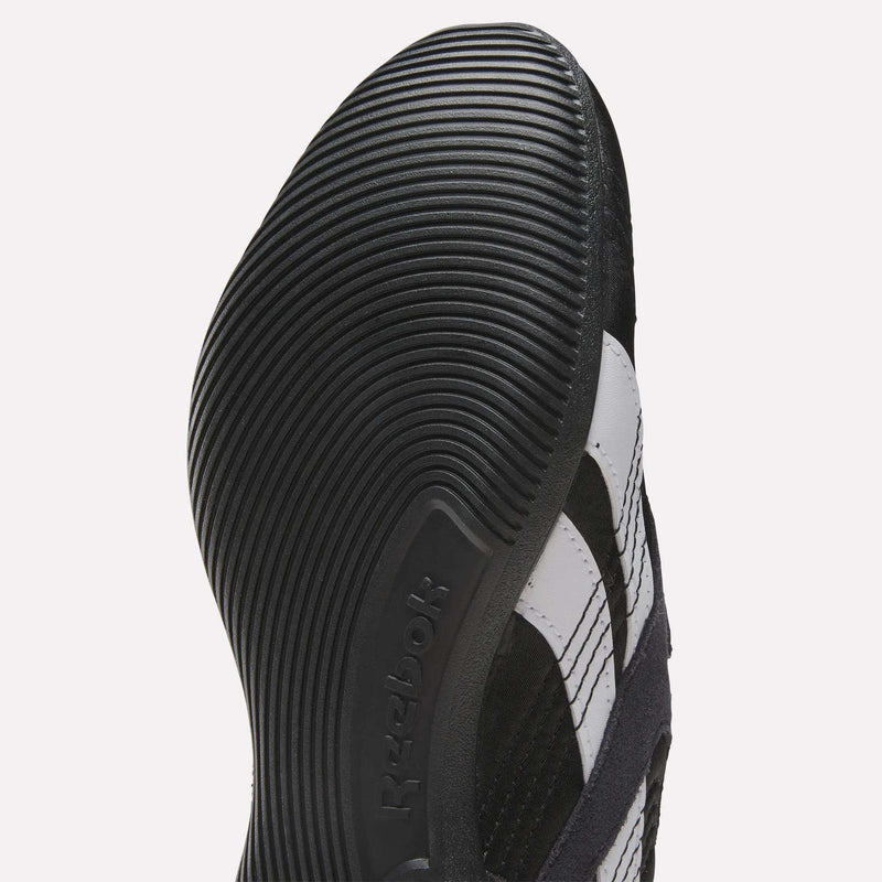 Close-up view of the sole of a Reebok Women's Ultra Lo Mary Jane Shoe, featuring textured grooves and the Reebok logo embossed on the side.